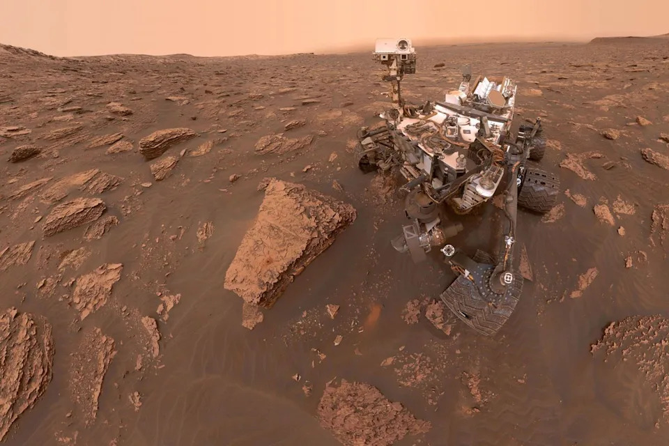 An exclusive photo of NASA's Curiosity Mars rover shows the robot in a dug-out sample area called 
