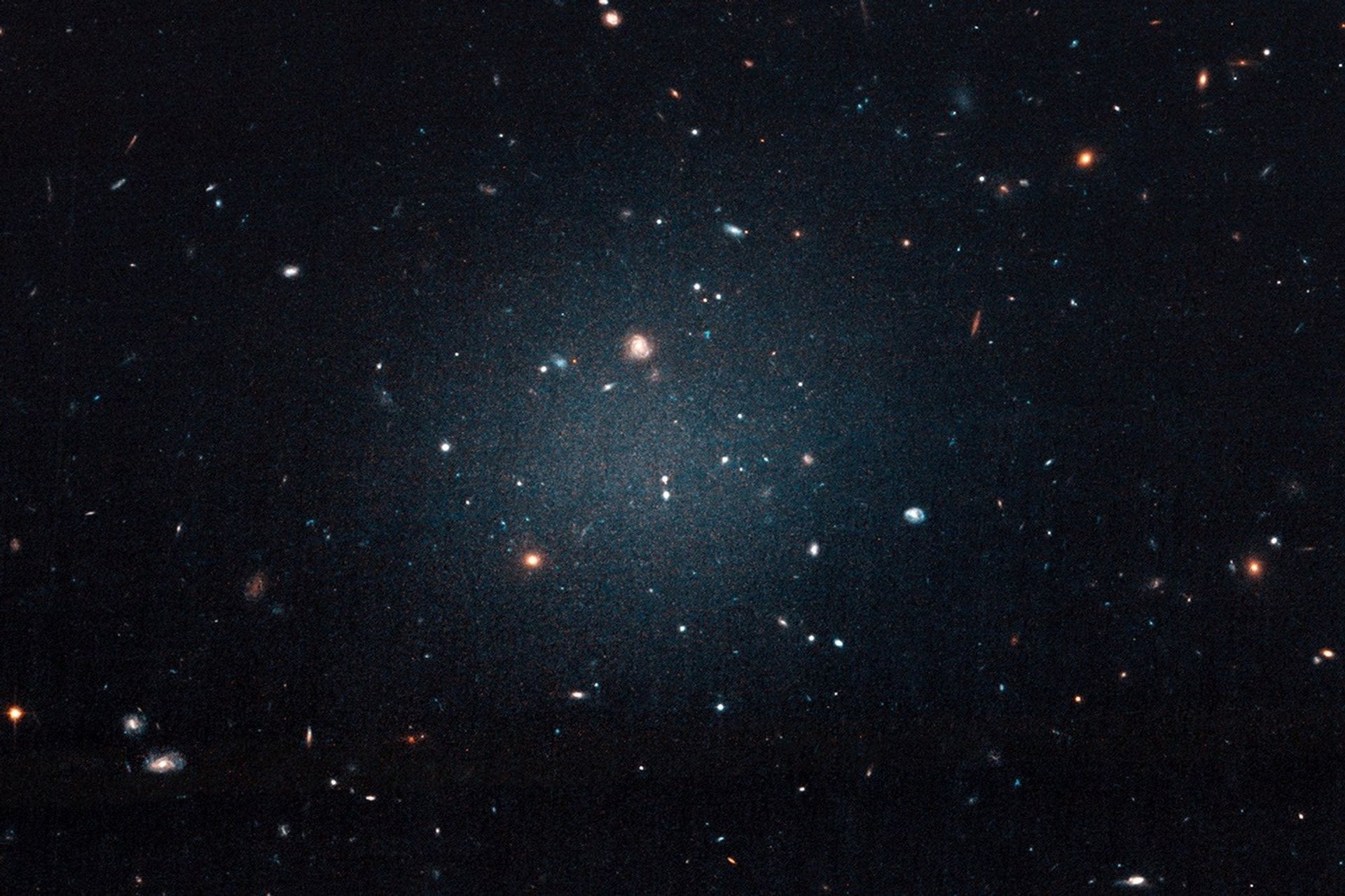 Image of the NGC 1052-DF2 Ultra Diffuse Galaxy that started the chain of discoveries of galaxies lacking dark matter. Credit - NASA, ESA, and P. van Dokkum (Yale)